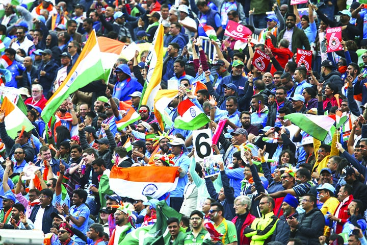 Indian fans celebrate a six during the ICC World Cup Cricket match between India and Pakistan at Old Trafford in Manchester, England on Sunday.
