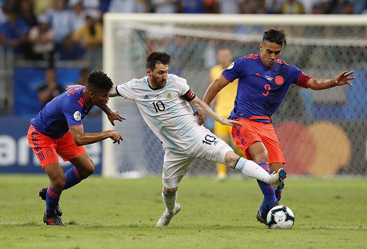 Argentina's Lionel Messi (center) Colombia's Radamel Falcao Garcia (right) and Colombia's Wilmar Barrios fight for the ball during a Copa America Group B soccer match at the Arena Fonte Nova in Salvador, Brazil on Saturday.