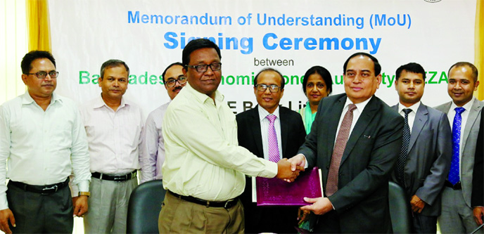 Managing Director of ONE Bank Ltd M Fakhrul Alam and Joint Secretary of Bangladesh Economic Zones Authority (BEZA) Md Shoab, exchanging a Memorandum of Understanding (MoU) signing document at the BEZA conference room in the city. As per the deal, ONE Bank