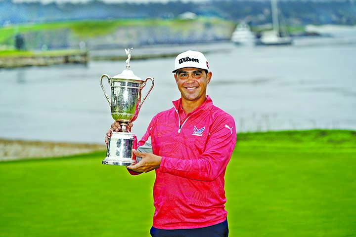 Gary Woodland posses with the trophy after winning the U.S. Open Championship golf tournament in Pebble Beach, Calif on Sunday.