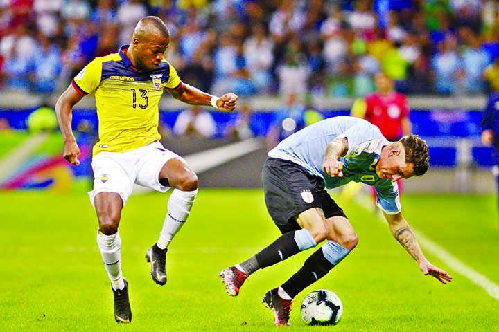 Ecuador's Enner Valencia (left) and Uruguay's Jose Gimenez battle for the ball during a Copa America Group C soccer match at the Mineirao stadium in Belo Horizonte, Brazil on Sunday.