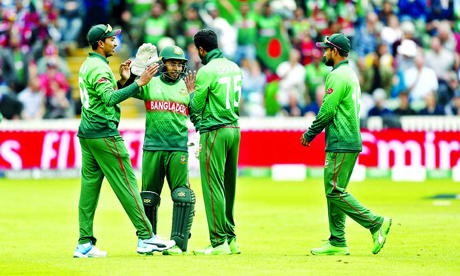 Bangladesh's Shakib Al Hasan ( third from left) celebrates after taking the wicket of West Indies' Nicholas Pooran during the ICC World Cup Cricket match between West Indies and Bangladesh at the Taunton County Ground in Taunton, south west England on M