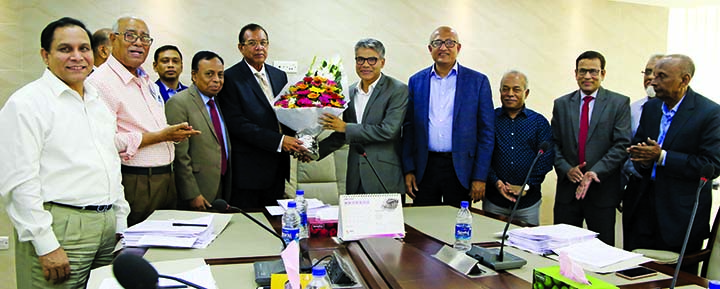 SM Amzad Hossain, Chairman of the Board of Directors of South Bangla Agriculture and Commerce (SBAC) Bank Ltd, congratulating the newly appointed Independent Director of the Bank Md Sajidur Rahman with floral wreath at its 91st Board Meeting at the Bank'