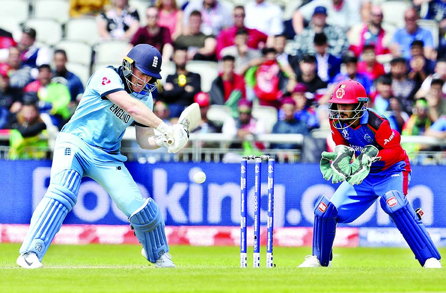 England's captain Eoin Morgan (left) bats during the ICC World Cup Cricket match between England and Afghanistan at Old Trafford in Manchester on Tuesday. Morgan hammered 148, which powered England to pile up a huge 397 for the loss of six wickets in th