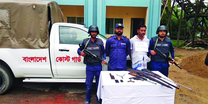 NOAKHALI: Members of Coast Guard arrested top terror and robber Farid with fire arms and bullets from Solaman Bazar in Hatia Upazila on Monday.