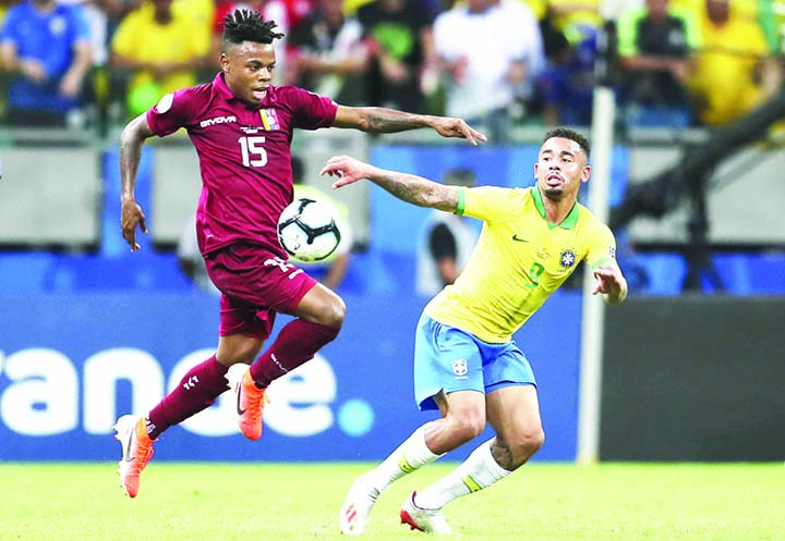 Venezuela's Jhon Murillo (left) controls the ball next to Brazil's Gabriel Jesus during a Copa America Group A soccer match at the Arena Fonte Nova in Salvador, Brazil on Tuesday.