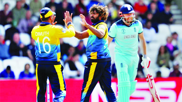 Lasith Malinga (centre) of Sri Lanka celebrates with his teammate Dimuth Karunaratne after dismissal of Jonny Bairstow (extreme right) during the match of the ICC World Cup Cricket between England and Sri Lanka at Leeds in England on Friday.