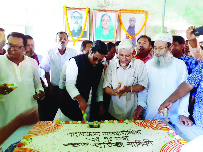 DAMUDYA (SHARIATPUR): Nahim Razzak MP cutting cake marking the 70th founding anniversary of Awami League at the party office in Damudya Upazila yesterday.