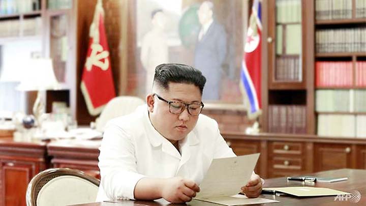 North Korean leader Kim Jong Un reading a personal letter from US President Donald Trump.
