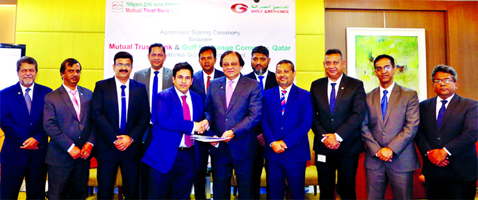 Jaafar Ali Al-Sarraf, General Manager of Gulf Exchange Company of Qatar and Anis A Khan, Managing Director of Mutual Trust Bank Ltd, exchanging an agreement signing document at the Bank's corporate office in the capital on Monday. Raju Ramachandran, Oper