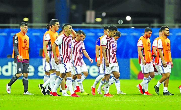 Paraguay soccer players leave the pitch at the end of a Copa America Group B soccer match against Colombia at the Arena Fonte Nova in Salvador, Brazil on Sunday. Colombia won 1-0.