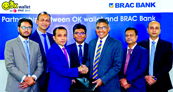 Gazi Yar Mohammed, Head of Agent Banking of ONE Bank and Nazmur Rahim, Head of Retail Banking of BRAC Bank, exchanging an agreement signing document at a city hotel recently. Under the deal, OK Wallet users will be able to transfer fund to BRAC Bank accou