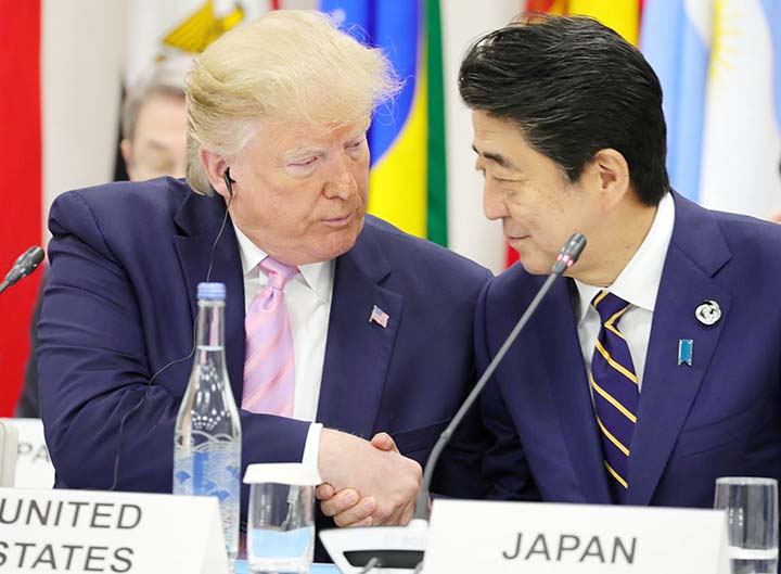 Japan's Prime Minister Shinzo Abe shakes hands with U.S. President Donald Trump during the G20 summit in Osaka, Japan.