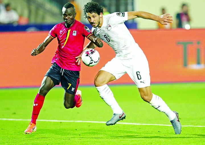 Uganda's Emmanuel Arnold Okwi and Egypt's Ahmed Hegazi (right) fight for the ball during the Africa Cup of Nations group A soccer match between Egypt and Uganda in Cairo International Stadium in Cairo, Egypt on Sunday.