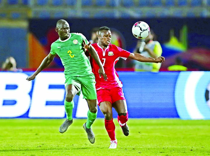 Senegal's Saliou Ciss (left) duels for the ball with Kenya's Masika Ayb Timbe during the Africa Cup of Nations group D soccer match between Kenya and Senegal in 30 June Stadium in Cairo, Egypt on Monday.