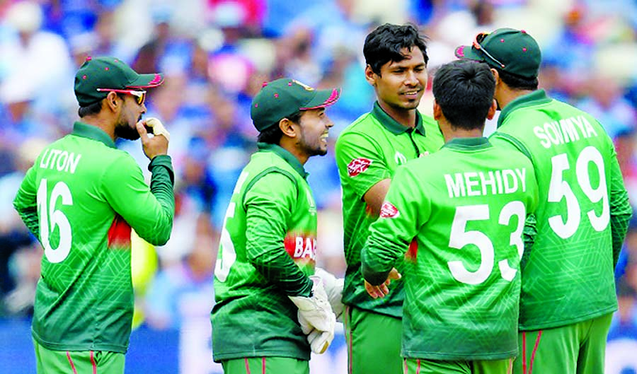 Mustafizur Rahman (centre) celebrates with his teammates after dismissal of Mohammad Shami in their match of the ICC World Cup Cricket between Bangladesh and India at Birmingham in England on Tuesday.