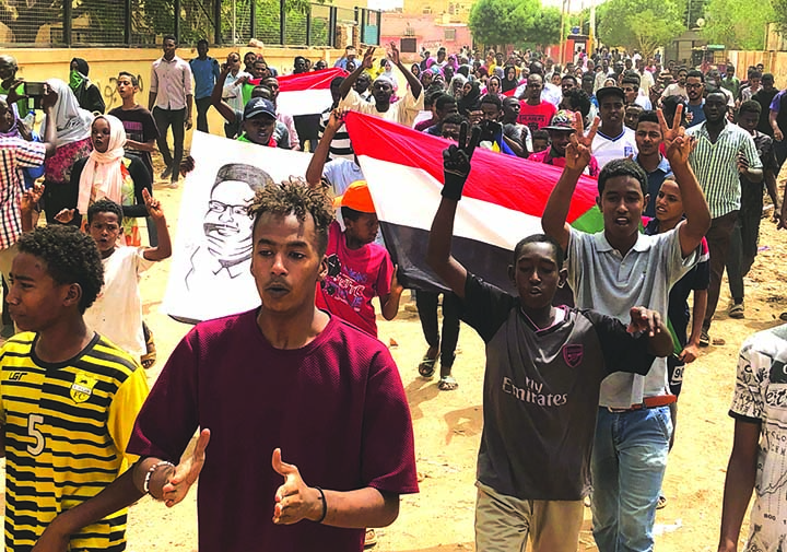 Sudanese protesters shout slogans during a demonstration against the ruling military council, in Khartoum, Sudan on Sunday.