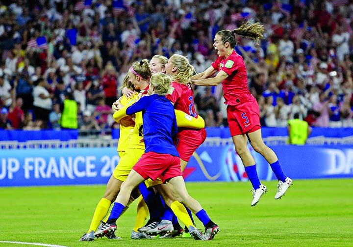 United States' players celebrate at the end of the Women's World Cup semifinal soccer match between England and the United States, at the Stade de Lyon, outside Lyon, France on Tuesday.