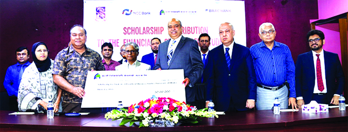 Prof Dr Akhtaruzzaman, Vice-Chancellor of Dhaka University (DU), handing over scholarship to the meritorious and financial challenged students of Faculty of Business Studies of the university at DU campus on Thursday. Syed Waseque Md Ali, Managing Directo