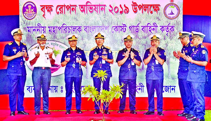Director General of Bangladesh Coastguard Rear Admiral M Ashraful Haque along with others offering munajat after inaugurating National Tree Plantation Campaign-2019 by planting a sapling at the Headquarter of Coastguard in the city's Agargaon on Thursday