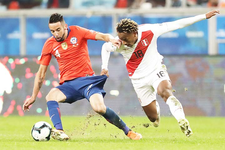 Chile's Mauricio Isla (left) vies for the ball with Peru's Andre Carrillo during a Copa America semifinal soccer match at the Arena do Gremio in Porto Alegre, Brazil on Wednesday.