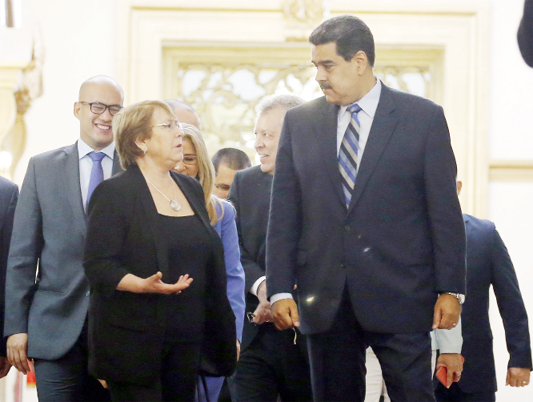 U.N. High Commissioner for Human Rights Michelle Bachelet, left, chats with Venezuela's President Nicolas Maduro, as they walk out of a meeting at Miraflores Presidential Palace, in Caracas, Venezuela on Friday.