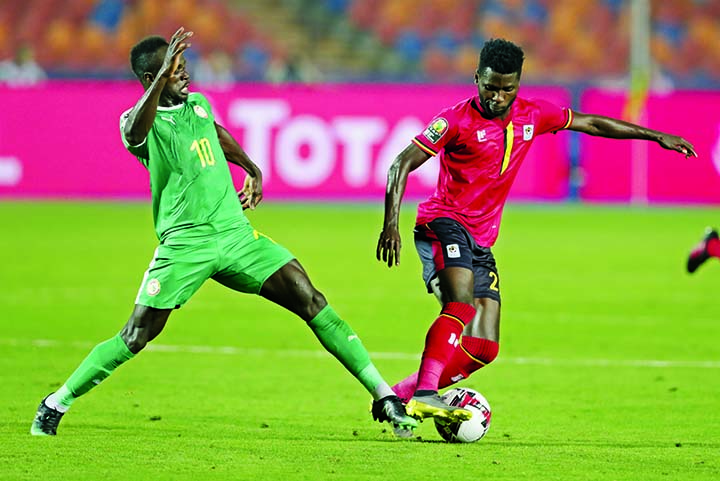 Uganda's Allan Kyambadde (right) and Senegal's Sadio Mane fight for the ball during the Africa Cup of Nations round of 16 soccer match between Uganda and Senegal in Cairo International stadium in Cairo, Egypt on Friday.