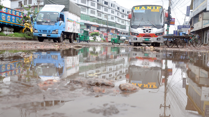Dilapidated road on Dhaka- Chattogram Highway at Alankar Point has turned worse after rainfall yesterday.