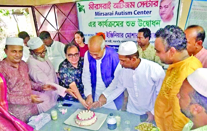 Engineer Mosharraf Hossain MP and other delegates cutting a cake at the inauguration event of the autism center at the office of Organisation for the Poor Community Advancement (OPCA) at Mostyan Nogor in Mirsharai on Friday.