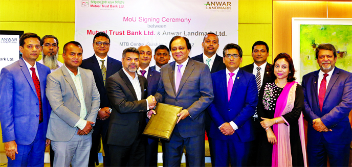 Hossain Khaled, Managing Director of Anwar Landmark Ltd and Anis A Khan, Managing Director of Mutual Trust Bank Ltd (MTB), exchanging agreement signing document at MTB centre in the city recently. Noor E Alam Siddike, Executive Director, Nazmul Khan Mojli