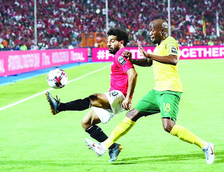 Egypt's Mohamed Salah controls the ball in front of South Africa's Sandile Hlanti during the Africa Cup of Nations round of 16 soccer match between Egypt and South Africa in Cairo International stadium in Cairo, Egypt on Saturday.