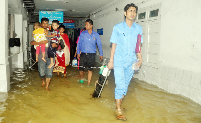 Patients leaving Agrabad Maa and Shishu Hospital as the hospital has went under water due to heavy rainfall yesterday.