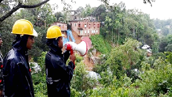 Volunteers alerting people using loudspeakers in Lalkhan Bazar and Motijharna areas fearing landslide in Chattogram on Sunday.