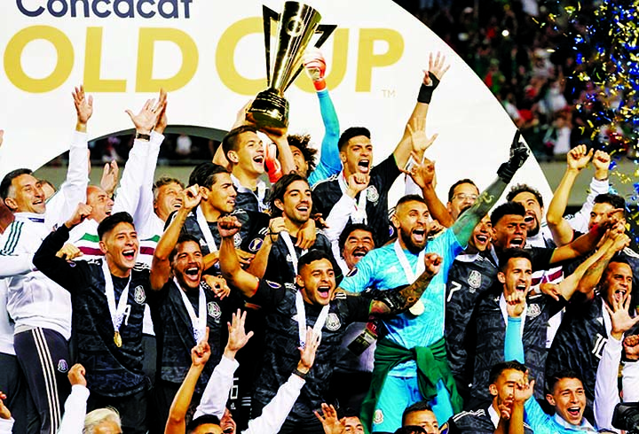 Mexico players celebrate with the Gold Cup after beating the US during the 2019 CONCACAF Gold Cup final football match between USA and Mexico at Soldier Field stadium in Chicago on Sunday.