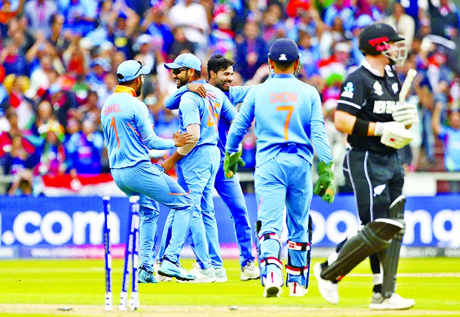 Indian cricketers celebrate the dismissal of New Zealand's Henry Nicholls (right) during the ICC World Cup Cricket semi-final match on Tuesday.