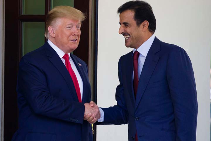 President Donald Trump shakes hands as he welcomes Qatar's Emir Sheikh Tamim bin Hamad Al Thani upon his arrival at the White House on Tuesday in Washington.