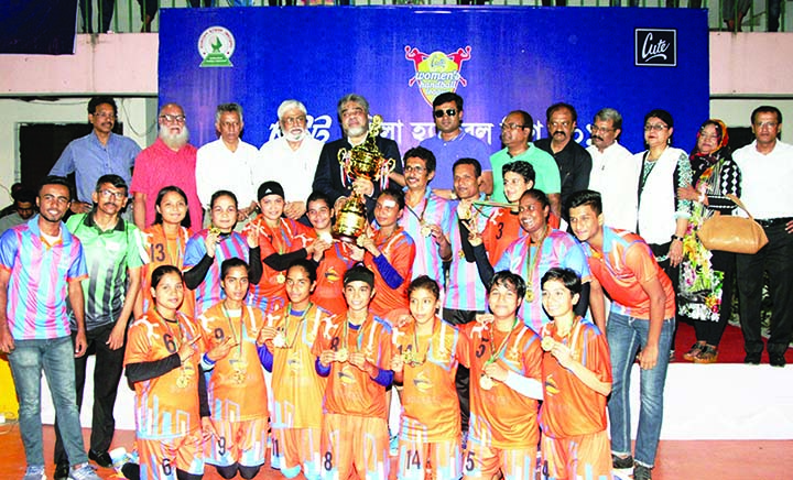 Dhaka Mariners Youngs Club, the champions in the Cute Women's Handball League with the guests and officials of Bangladesh Handball Federation pose for a photo session at the Shaheed (Captain) M Mansur Ali National Handball Stadium on Wednesday.