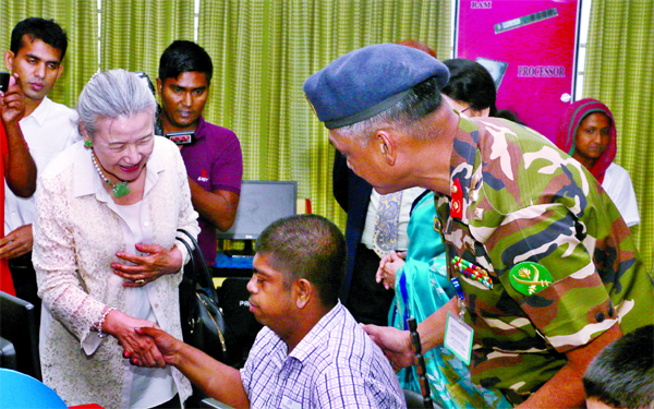 Visiting former UN Secretary General Ban Ki-moon's wife Ms Yoo Soon-Taek shakes hand with a member of 'Kendrio Prayas' located at Dhaka Cantonment set up by the Bangladesh Army on Wednesday.