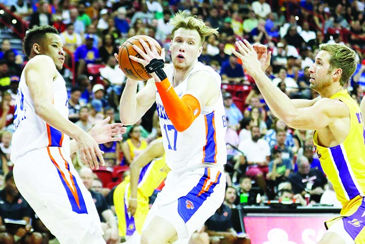 New York Knicks' Ignas Brazdeikis grabs a rebound over Los Angeles Lakers' David Wear (right) during the second half of an NBA summer league basketball game in Las Vegas on Wednesday.