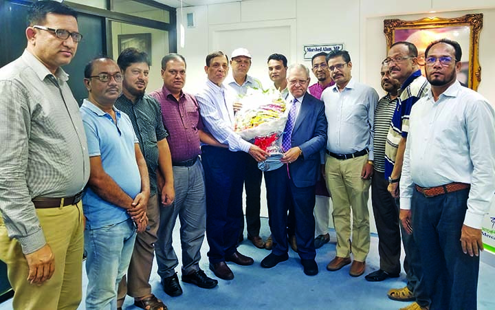 Newly -elected Chairman of Mercantile Bank Ltd Morshed Alam being greeted by Shahab Uddin, Upazila Chairman of Companyganj and President of Noakhali District Association, Dhaka recently. The leaders of the association were also present at the ceremony.