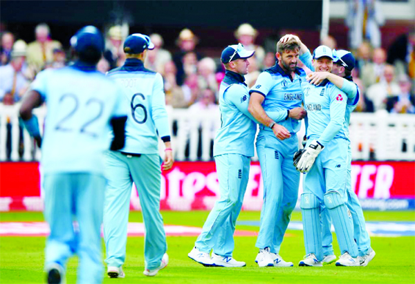 Players of England celebrate after dismissal of Kane Williamson (not in the picture) during the final match of the ICC World Cup Cricket between England and New Zealand at the Lord's in London on Sunday.