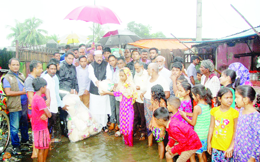 SYLHET: President of Sylhet City Awami League and former mayor Badar Uddin Ahmed Kamran distributing relief goods amoing the flood- hit people at Taranton area recently.