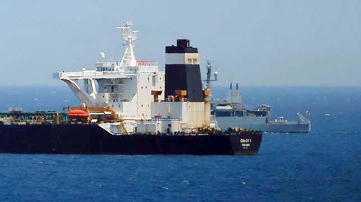 A British Royal Navy patrol vessel guards the oil supertanker Grace 1, that's on suspicion of carrying Iranian crude oil to Syria, as it sits anchored in waters of the British overseas territory of Gibraltar, historically claimed by Spain.
