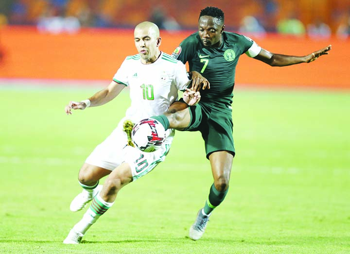 Algeria's Sofiane Feghouli (left) and Nigeria's Ahmed Musa fight for the ball during the Africa Cup of Nations semifinal soccer match between Algeria and Nigeria in Cairo International stadium in Cairo, Egypt on Sunday.