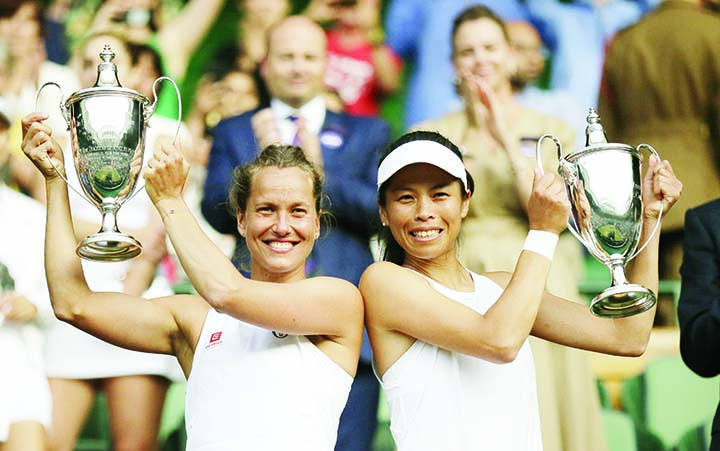 Czech Republic's Barbora Strycova (left) and Taiwan's Su-Wei Hsieh lift the trophies after defeating Canada's Gabriela Dabrowski and China's Yifan Xu in the women's doubles final match of the Wimbledon Tennis Championships in London on Sunday.
