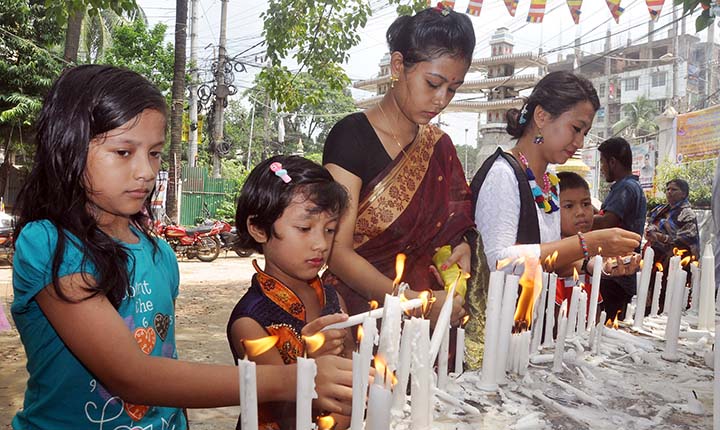 Members of Buddhist community lighting candles on the occasion of the Ashari Purnima yesterday.