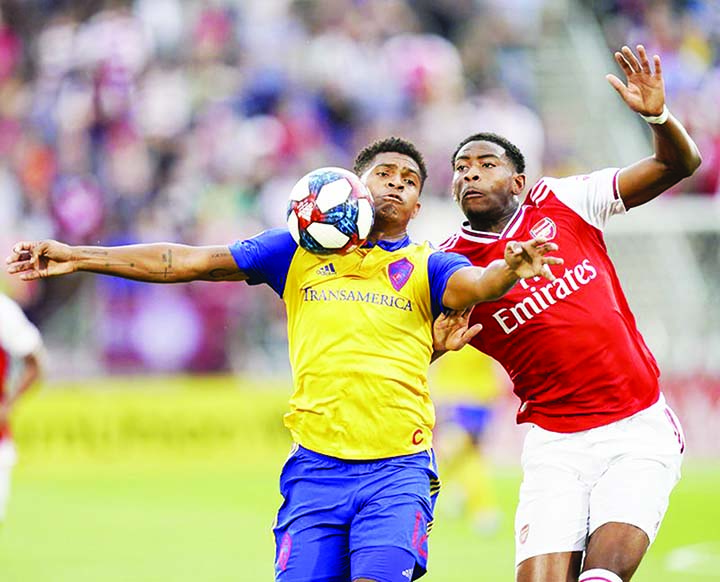 Colorado Rapids forward Niki Jackson (left) and Arsenal forward Tyreece John-Jules go after the ball during the first half of an international friendly soccer match in Commerce City, Colo on Monday.