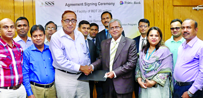 Md Touhidul Alam Khan, Deputy Managing Director of Prime Bank Limited and Md Abdul Hamid Bhuiyan, Executive Director of Society for Social Service (SSS), exchanging an agreement signing document at the bank's head office in the city recently for lending
