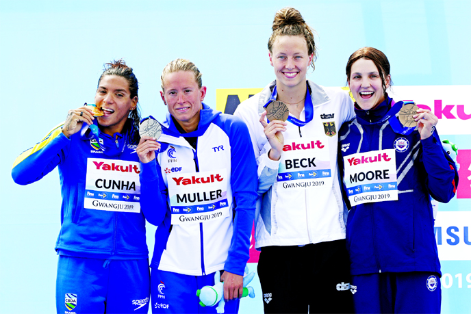 From left, gold medalist Ana Marcela Cunha of Brazil, silver medalist Aurelie Muller of France, and bronze medalists Leonie Beck of Germany and Hannah Moore of the United States stand with their medals after the women's 5km open water swim at the World S