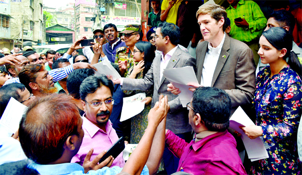 US Envoy to Bangladesh Robert Miller and DSCC Mayor Sayeed Khokon distributing leaflets in the old part of the city on Wednesday to raise mass awareness against dengue.